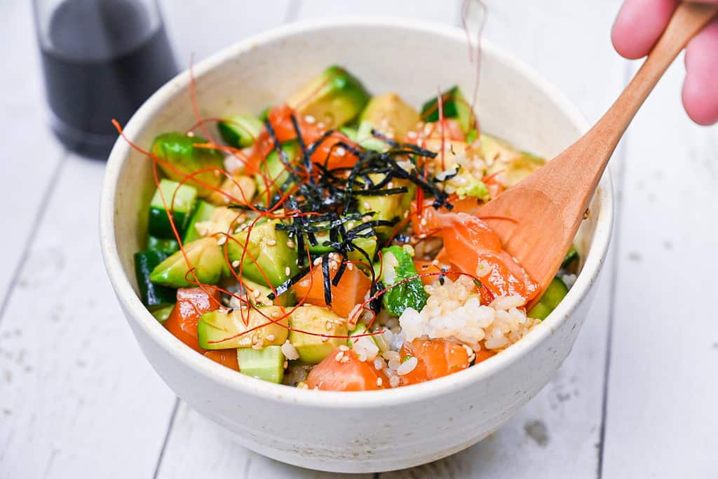 Finished salmon sashimi bowl with wooden spoon