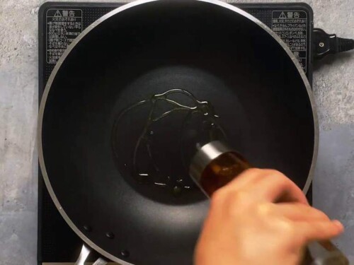 Adding oil to wok