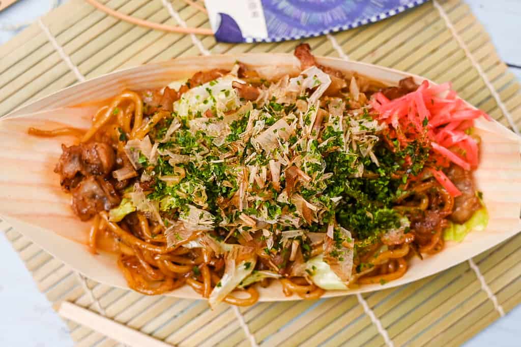 Japanese festival style yakisoba noodles in a bamboo boat top down horizonal
