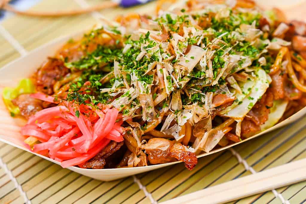 Japanese festival style yakisoba noodles in a bamboo boat close up