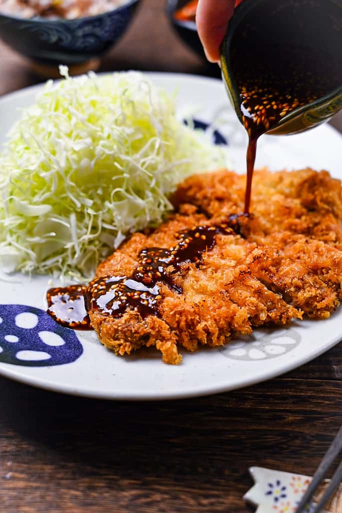 Japanese tonkatsu (deep fried pork cutlet) drizzled with tonkatsu sauce