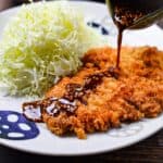 Japanese tonkatsu deep fried pork cutlet drizzled with homemade sauce