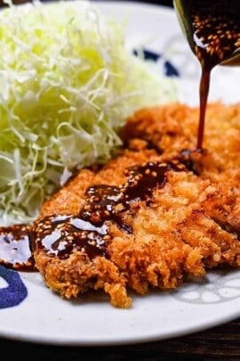 Japanese tonkatsu deep fried pork cutlet drizzled with homemade sauce