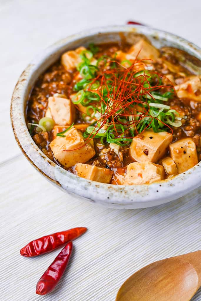 Mabo tofu topped with spring onion and chili threads