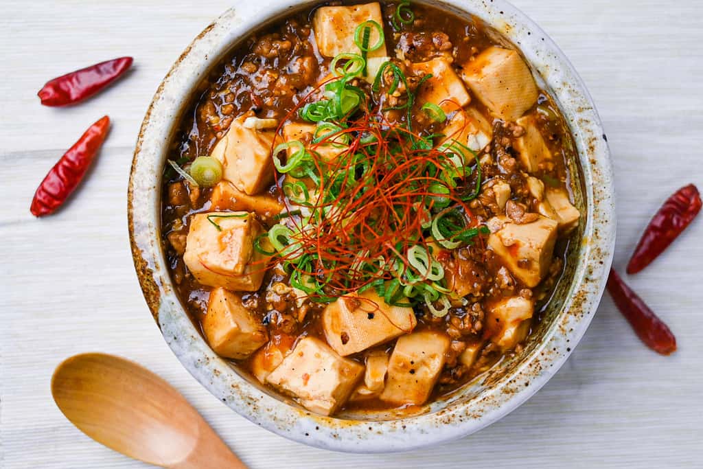 Mabo tofu topped with spring onion and chili threads top down