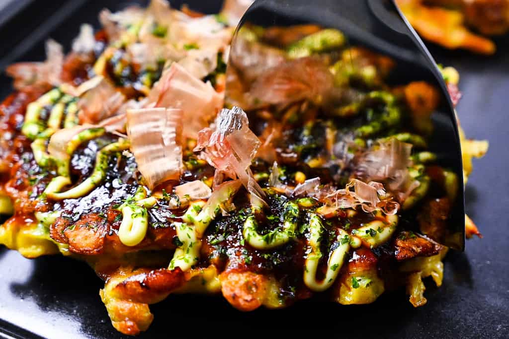 Cutting okonomiyaki with spatula