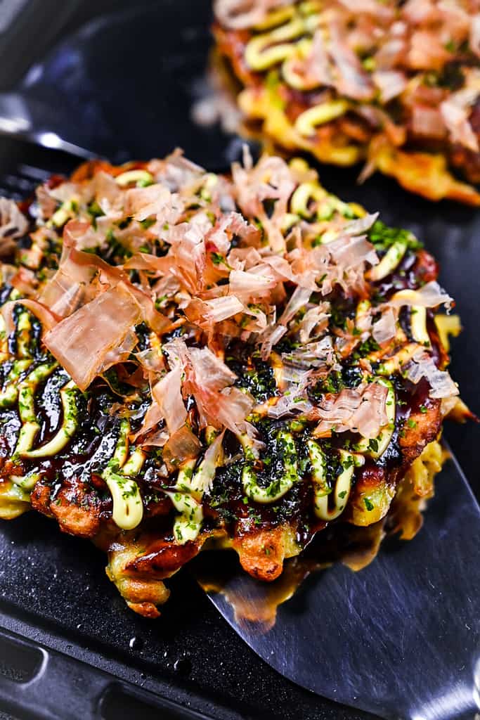 Japanese okonomiyaki pancake on a teppanyaki grill