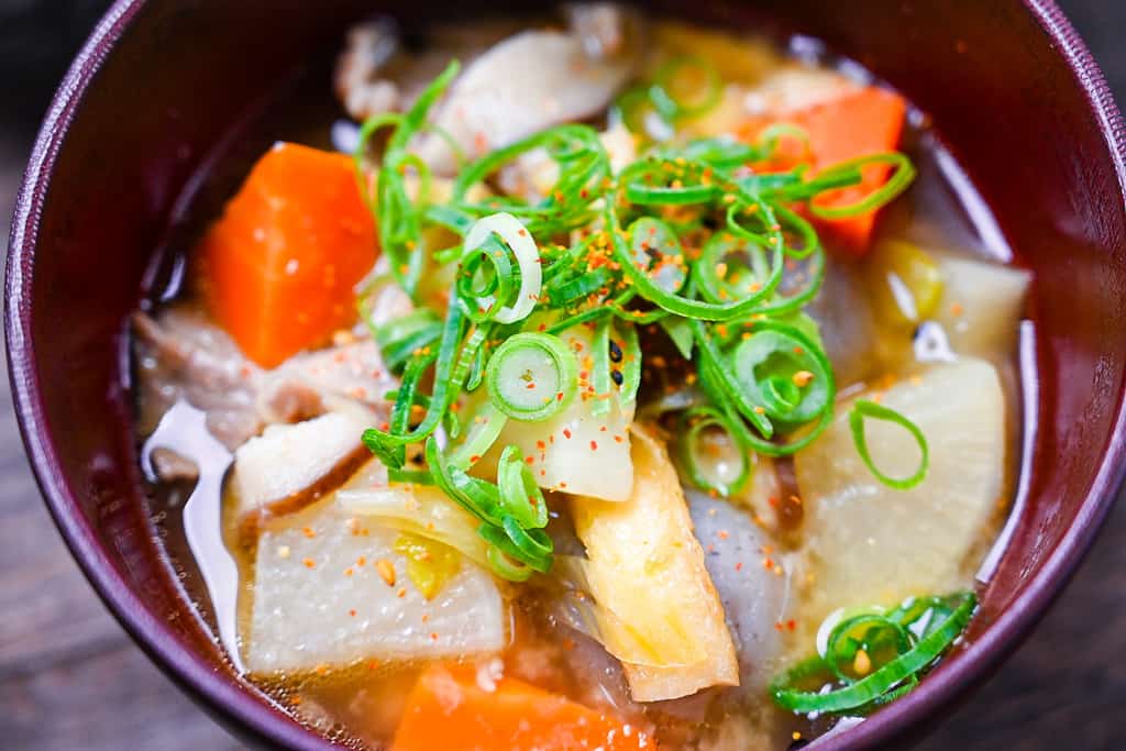 Tonjiru (pork and vegetable miso soup) sprinkled with shijimi close up