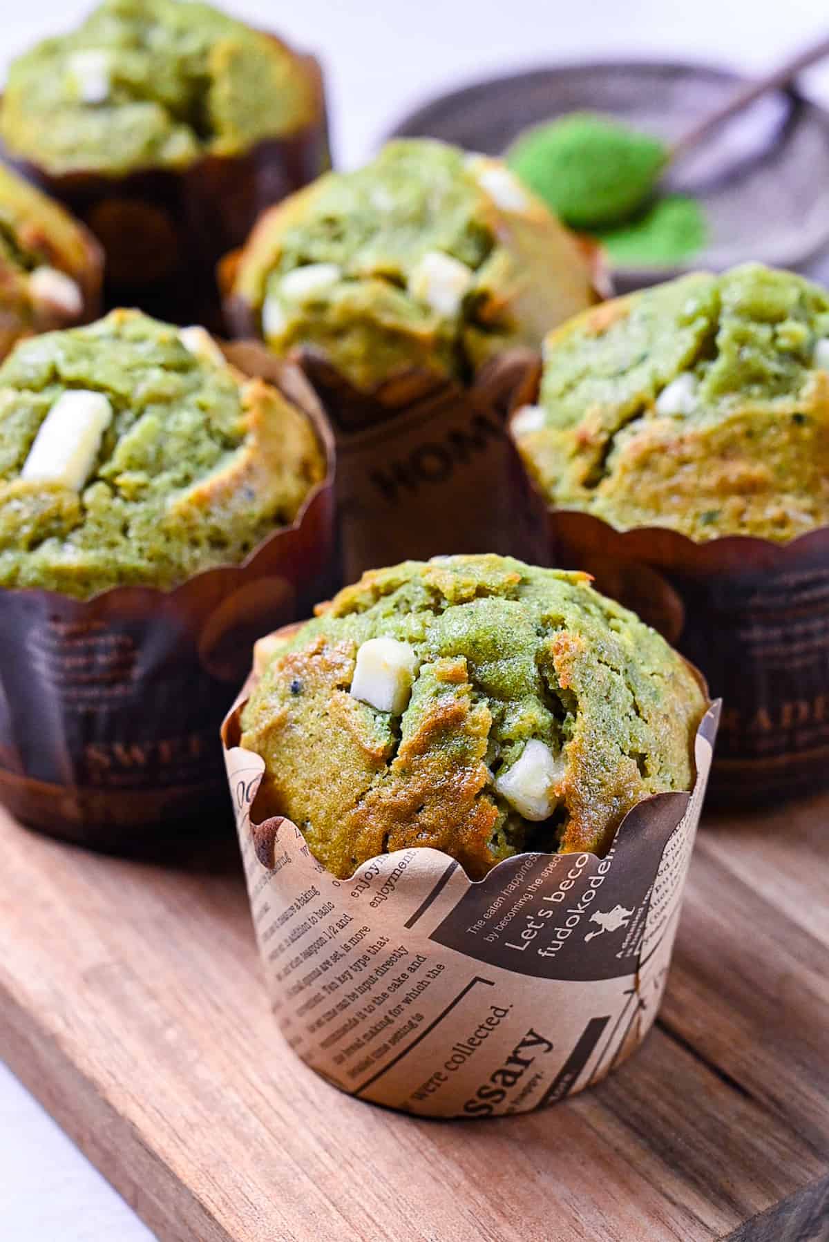 matcha and white chocolate muffin on a wooden chopping board