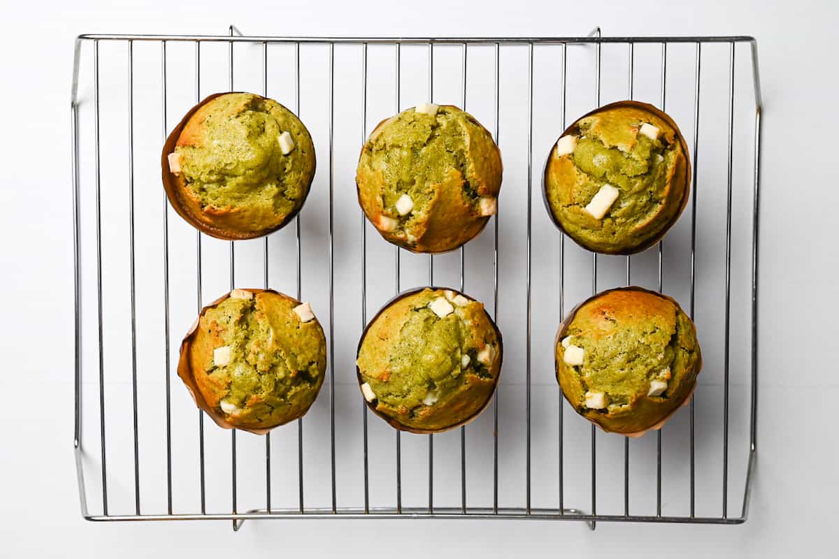 matcha muffins cooling on a wire rack