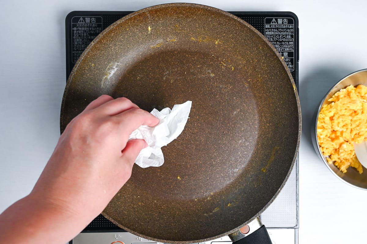 wiping pan with kitchen paper