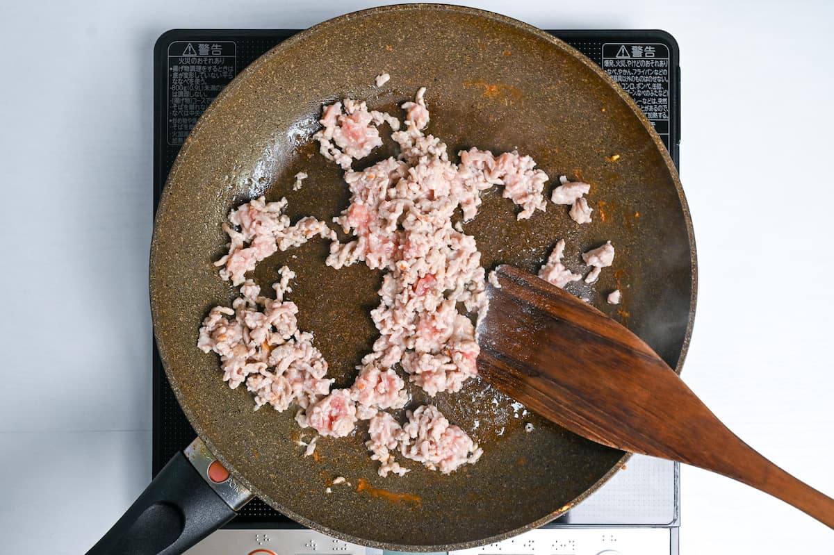 frying ground chicken in a frying pan