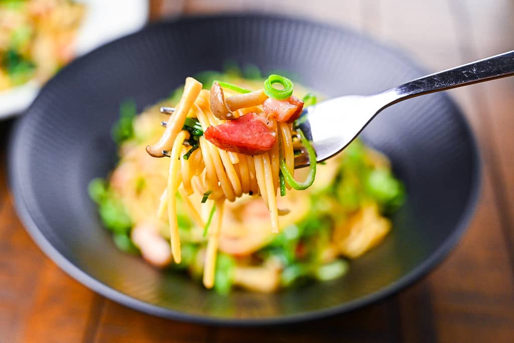 Mushroom and bacon wafu pasta on a fork