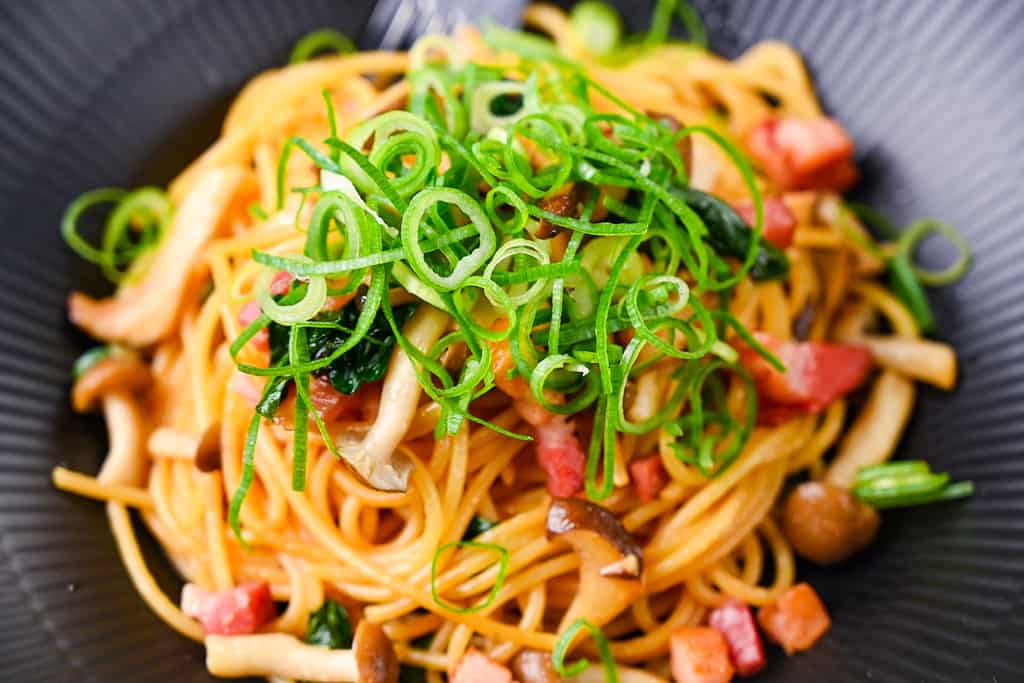 Japanese butter shoyu wafu pasta with bacon and mushrooms close up