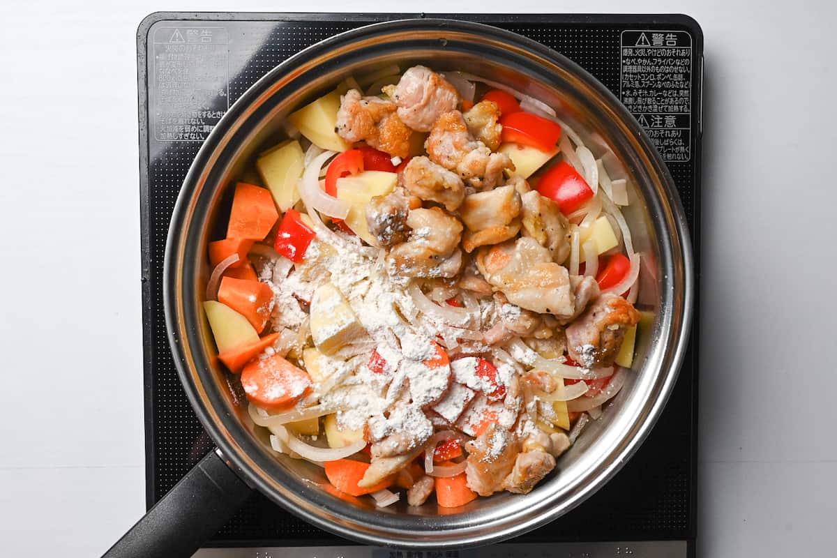 adding chicken and flour to the pan