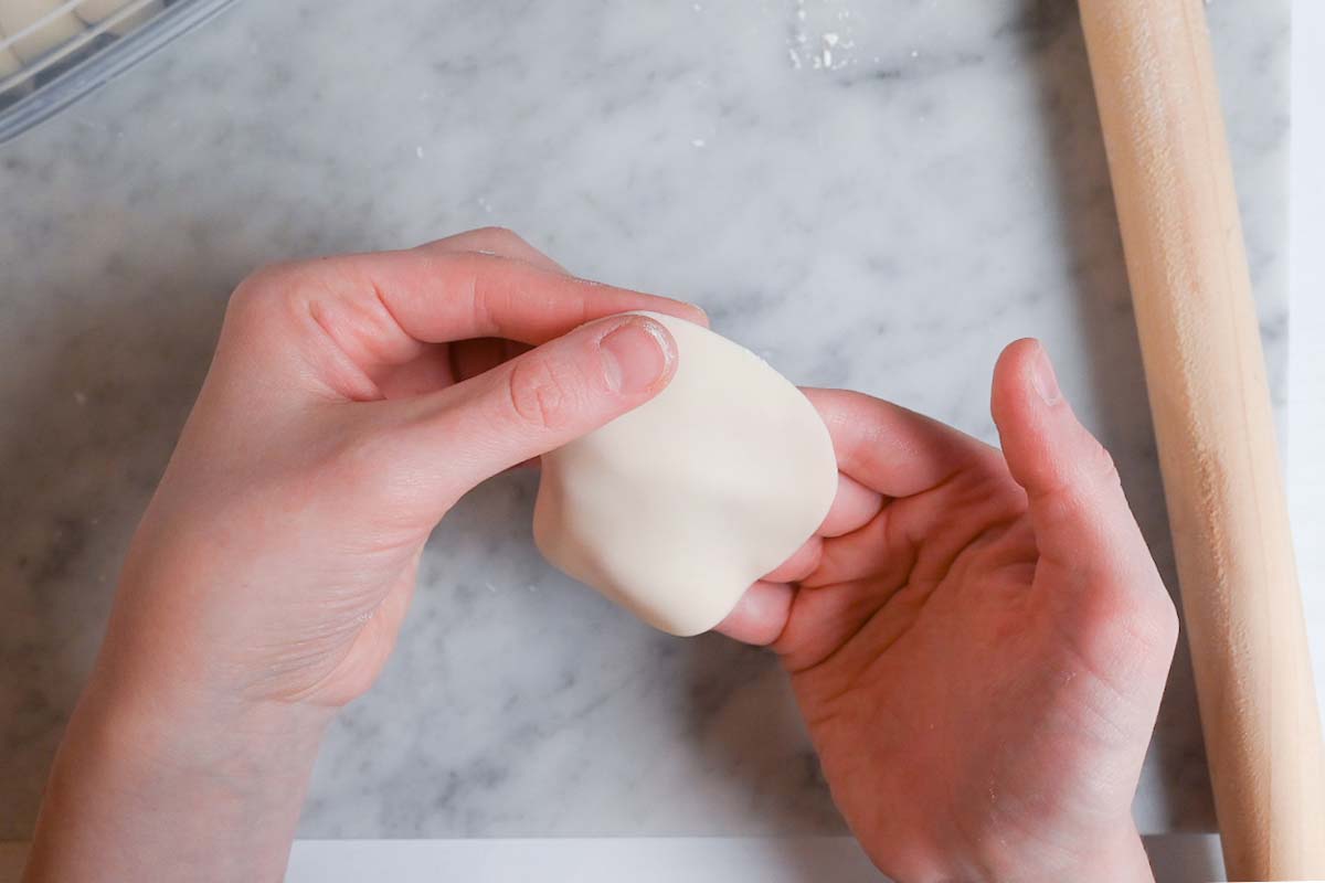 pinching the edges of homemade gyoza wrapper