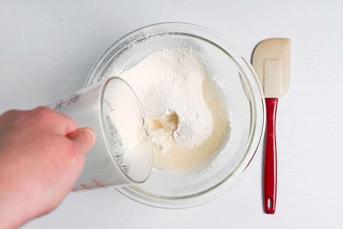 pouring hot water into flour