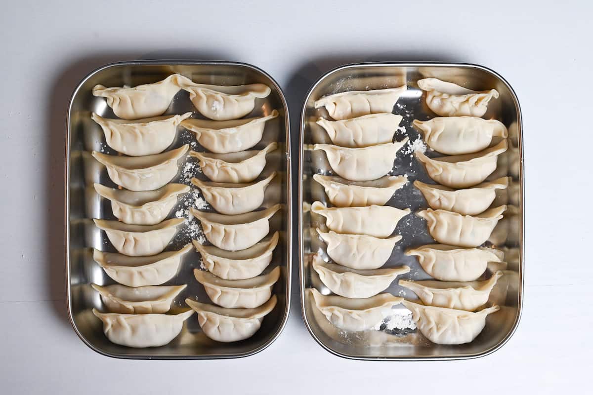 32 completed gyoza in two metal containers