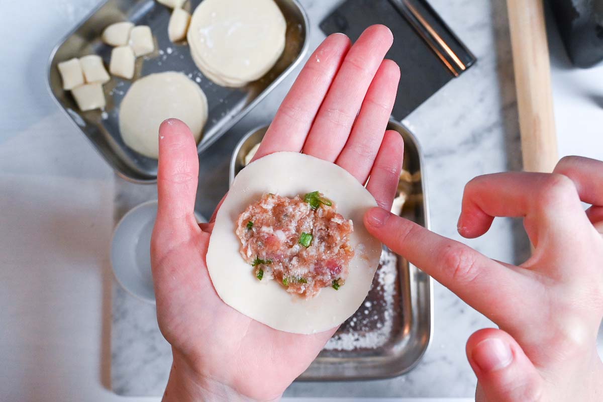 wetting the edge of the gyoza wrapper with water