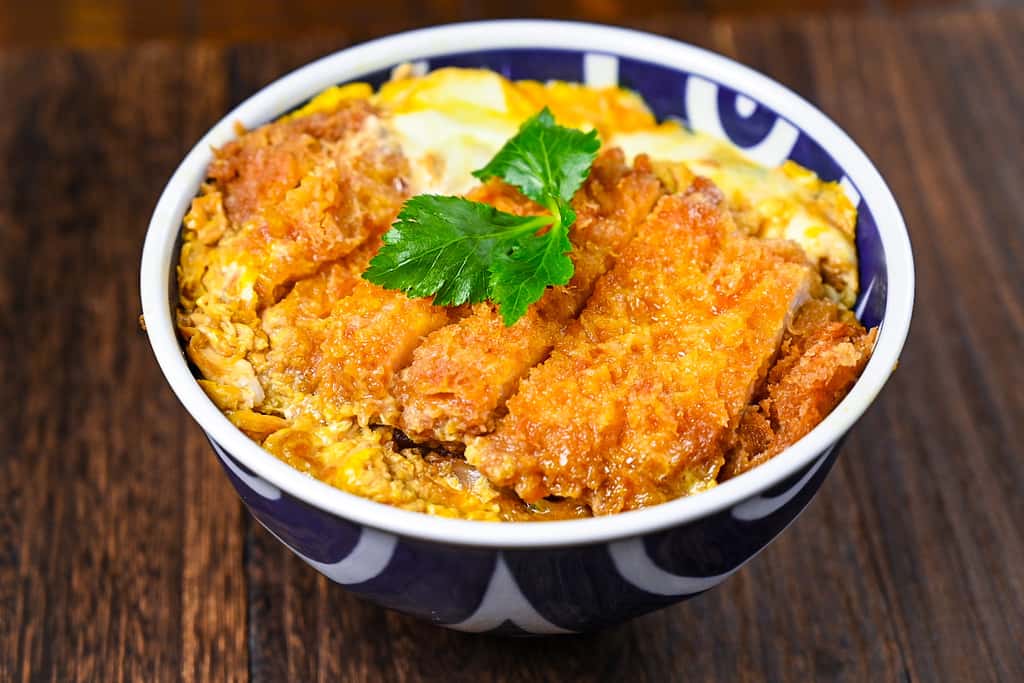 Japanese katsudon served in a blue and white bowl