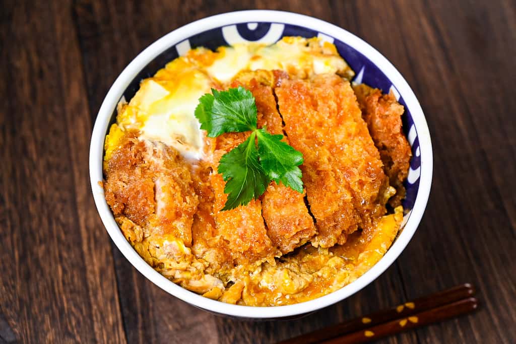 Japanese katsudon served in a blue and white bowl
