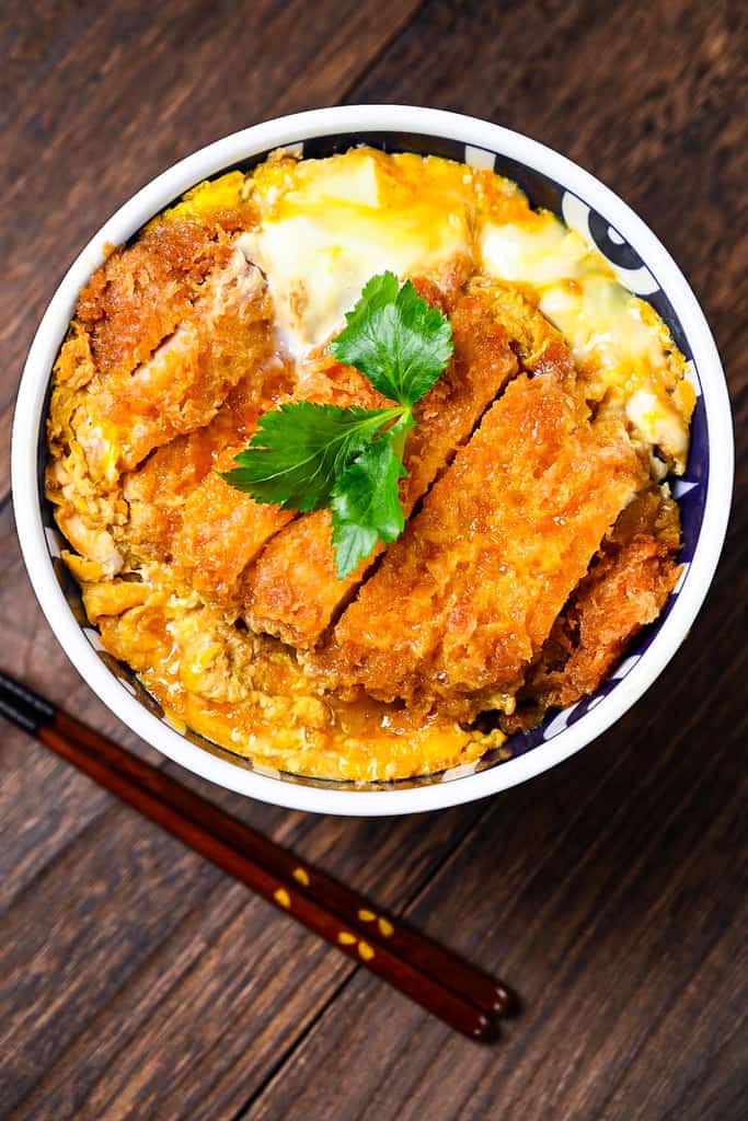 Japanese katsudon served in a blue and white bowl top down