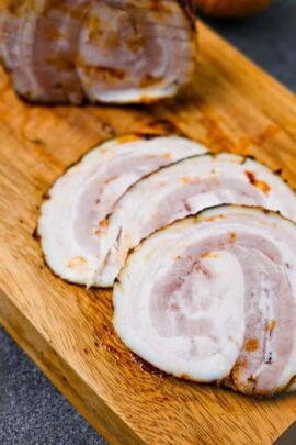 homemade Japanese chashu cut into three slices on a wooden chopping board