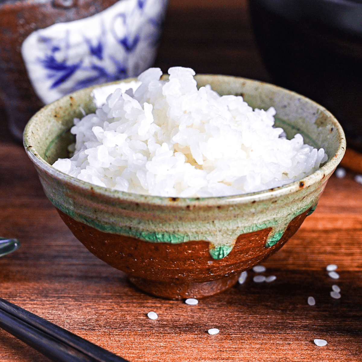 raw japanese rice in a green Japanese rice measuring cup