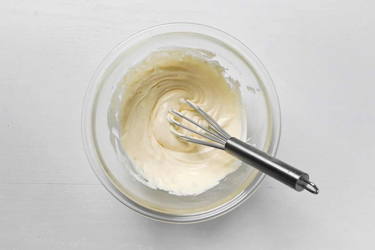 softened cream cheese whisked smooth in a large glass bowl