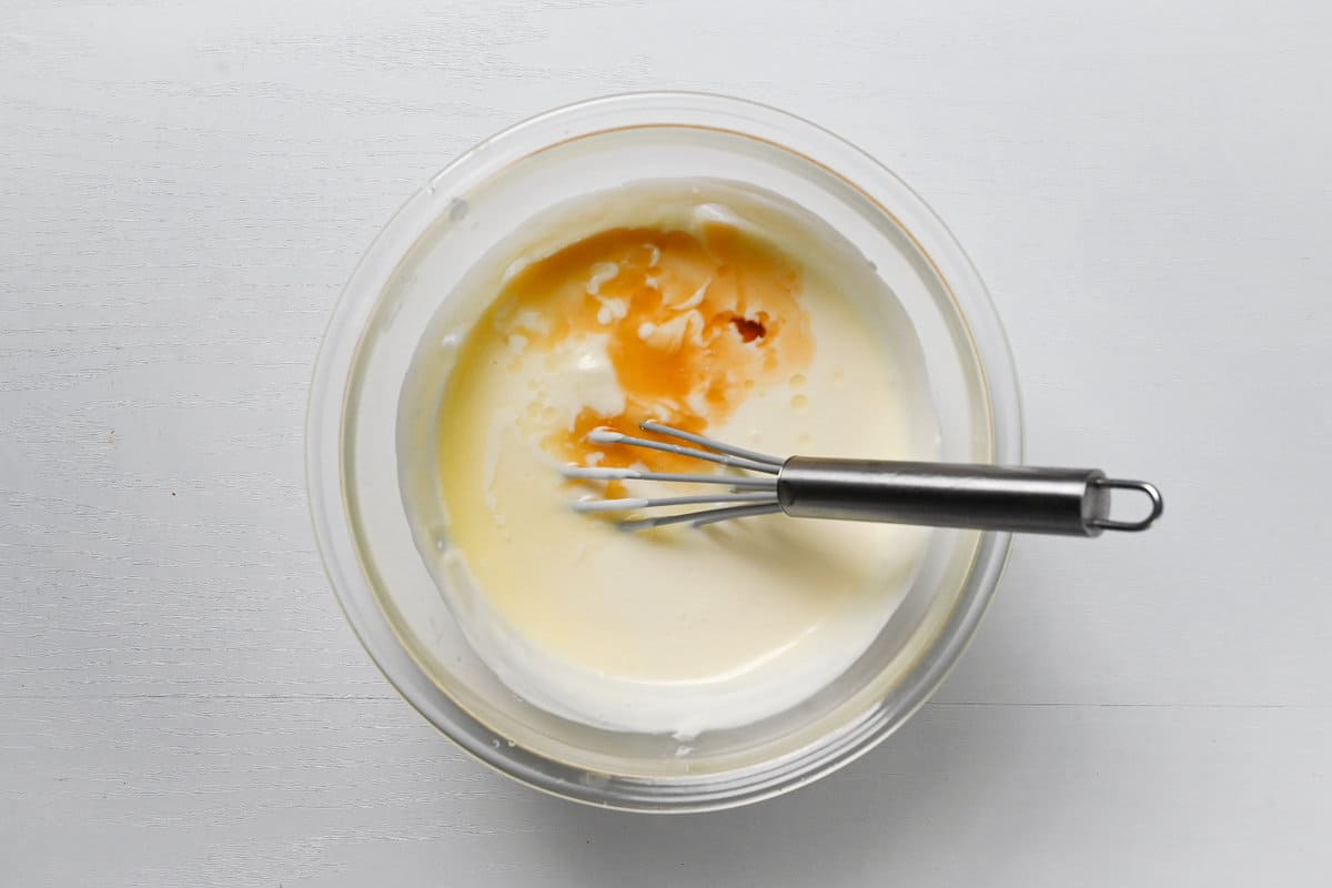 adding lemon juice and vanilla essence to cheesecake mixture