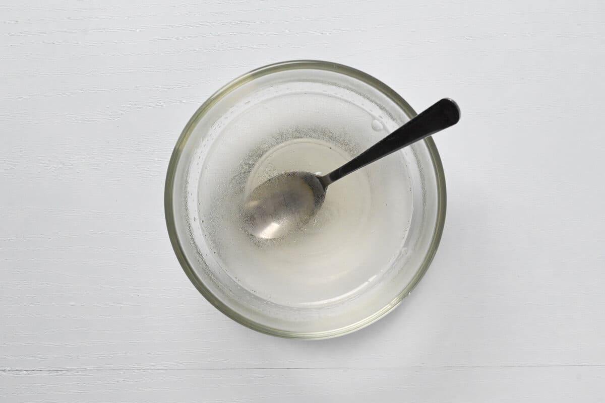 melted gelatine powder in a small glass bowl with silver spoon