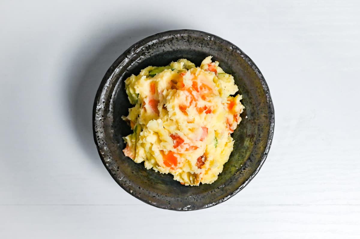 Final Japanese potato salad in a black serving bowl
