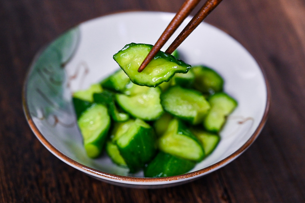 pciking up a piece of wasabi pickled cucumber with chopsticks