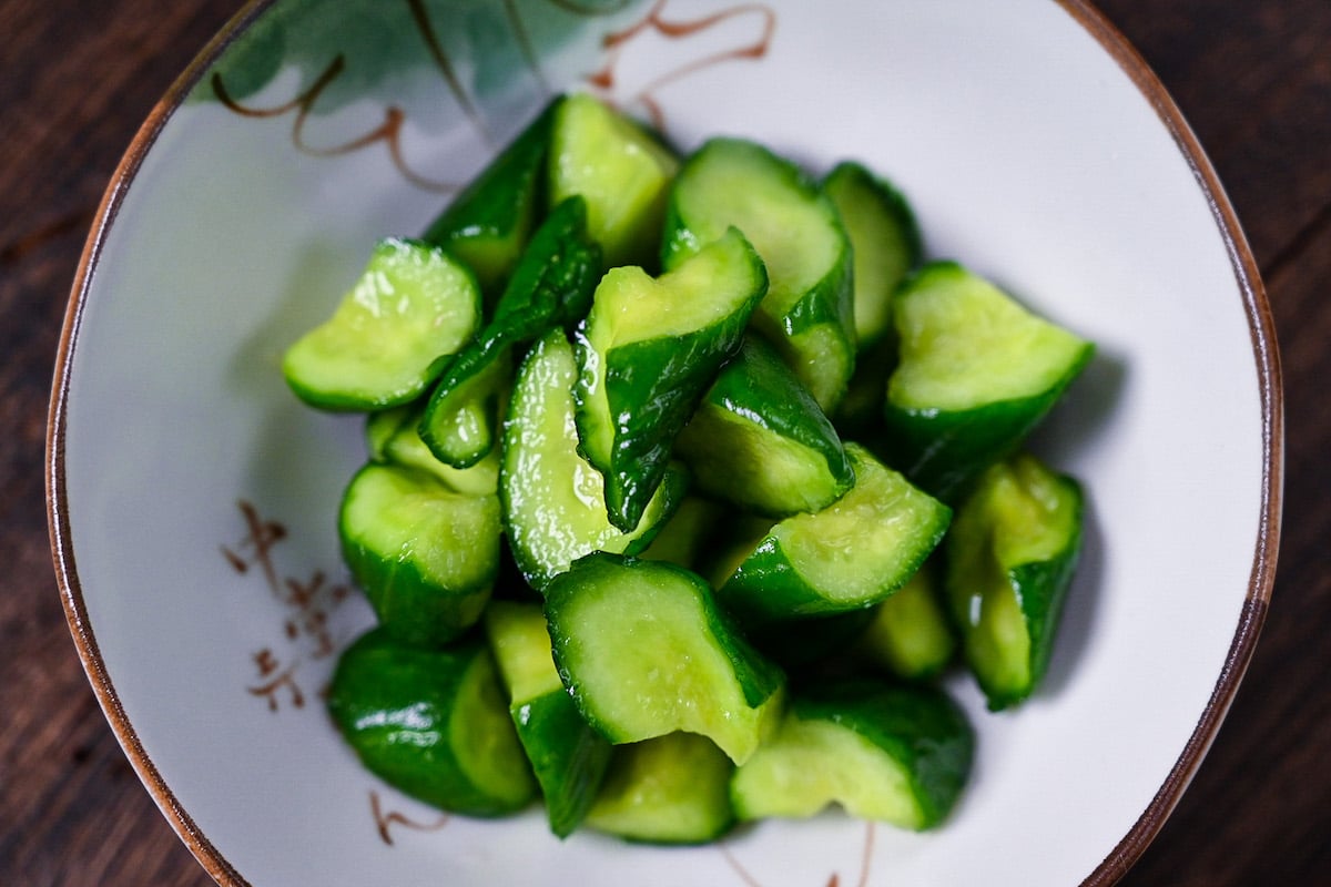 Japanese wasabi pickled cucumbers in a white dish top down view