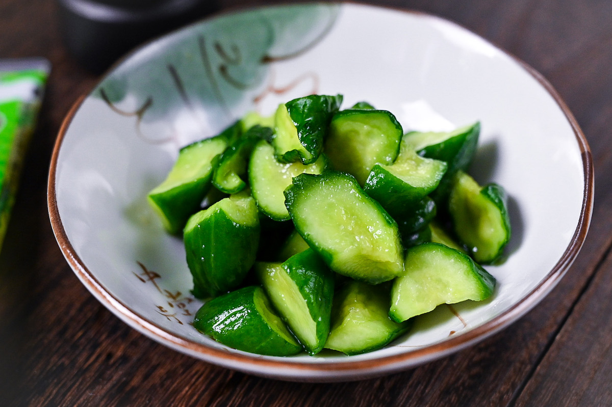 Japanese wasabi pickled cucumbers in a white dish side close up