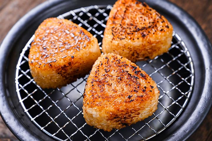 3 yaki onigiri rice balls on a charcoal grill