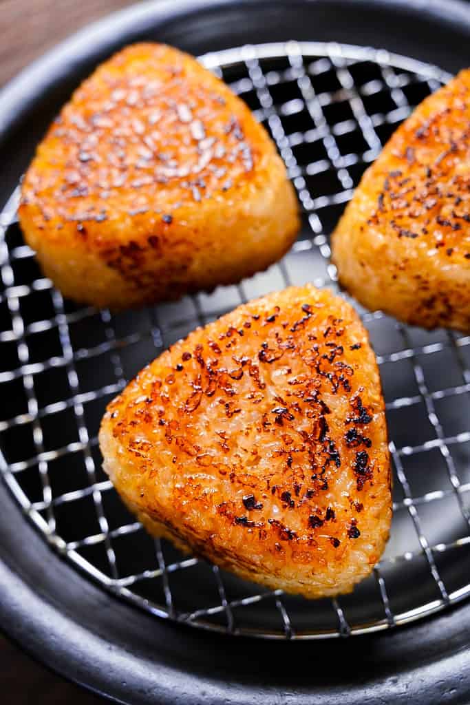 3 yaki onigiri rice balls on a charcoal grill