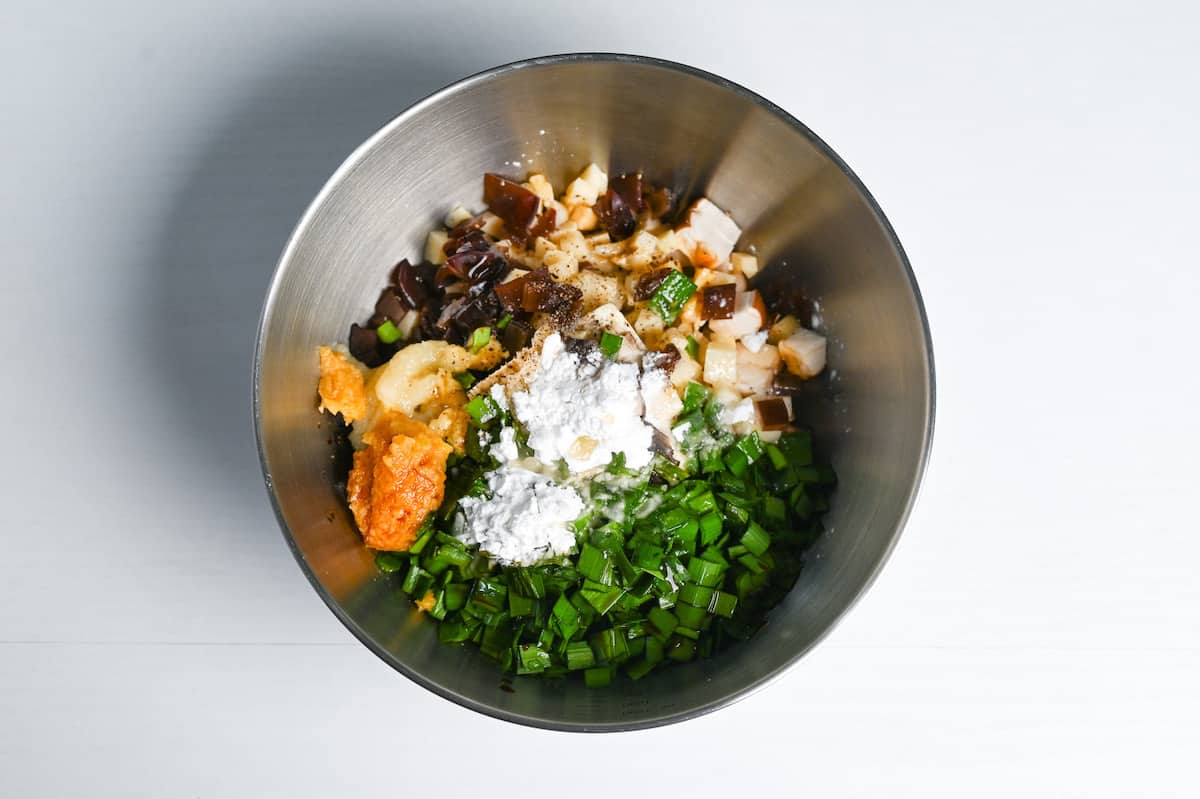 tofu and vegetable gyoza filling ingredients in a metal bowl
