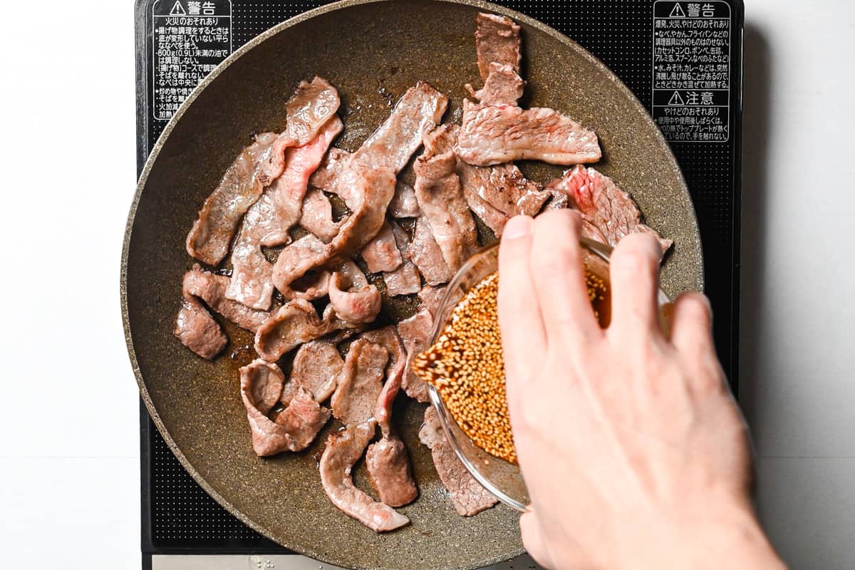 Pouring homemade yakiniku sauce in the pan