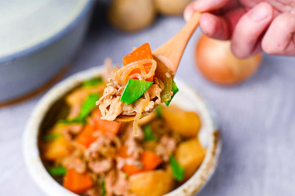 Japanese Nikujaga Meat and Potato Stew on a wooden spoon