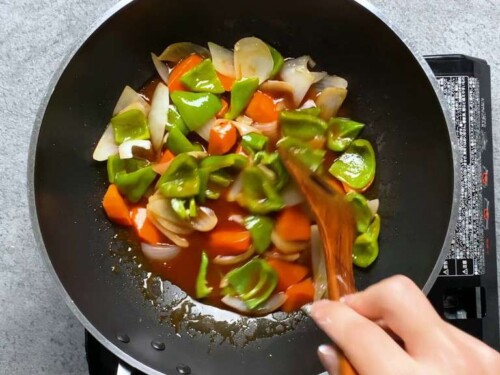 Frying the vegetables in the sweet and sour sauce