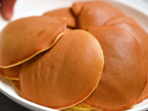 Making dorayaki: cooked pancakes on a white plate