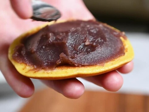 Making dorayaki: spreading red bean paste onto one pancake