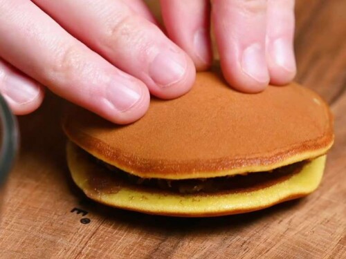 Making dorayaki: pressing a second pancake on top of the red bean paste