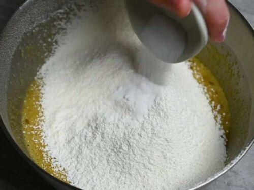 Making dorayaki: sifting flour into the mixture and adding baking soda