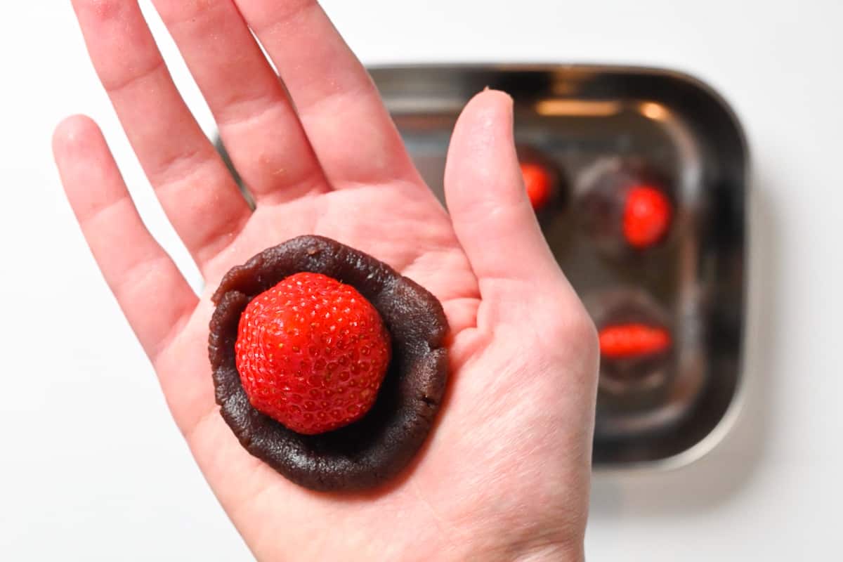 wrapping a strawberry with anko paste