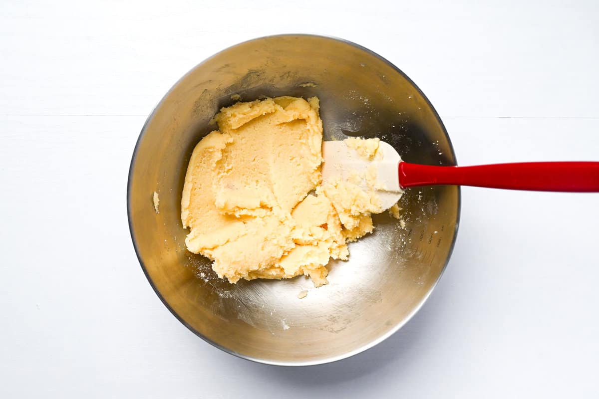 Butter and sugar combined in a mixing bowl