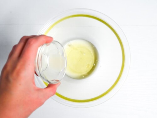 Pouring lemon juice into egg whites