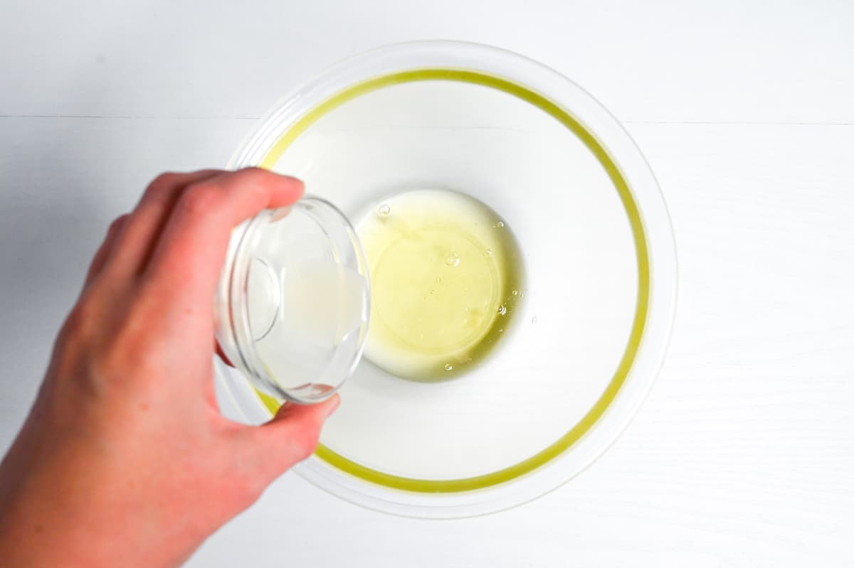 Pouring lemon juice into egg whites