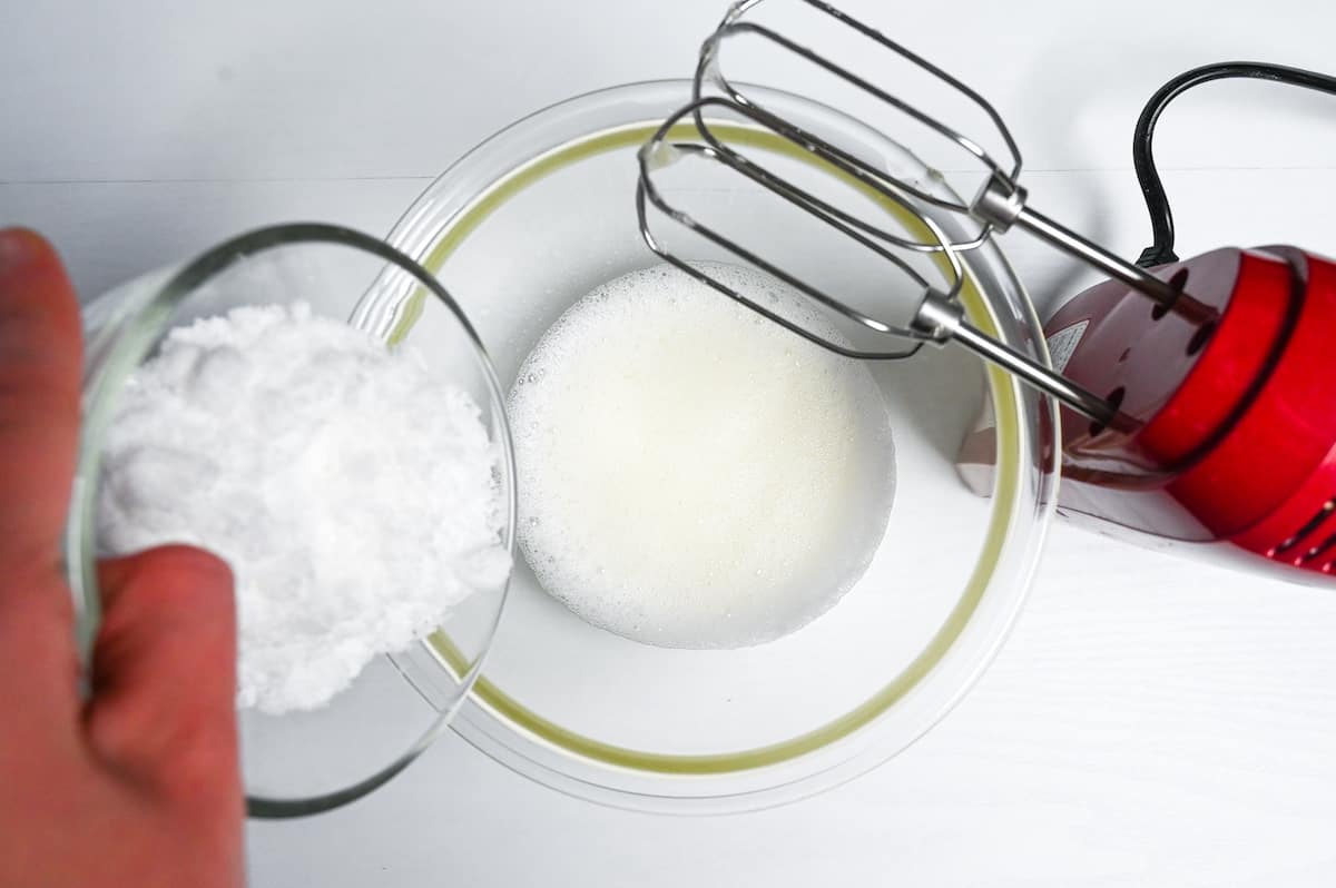 Adding one third of sugar to foamy whipped egg whites